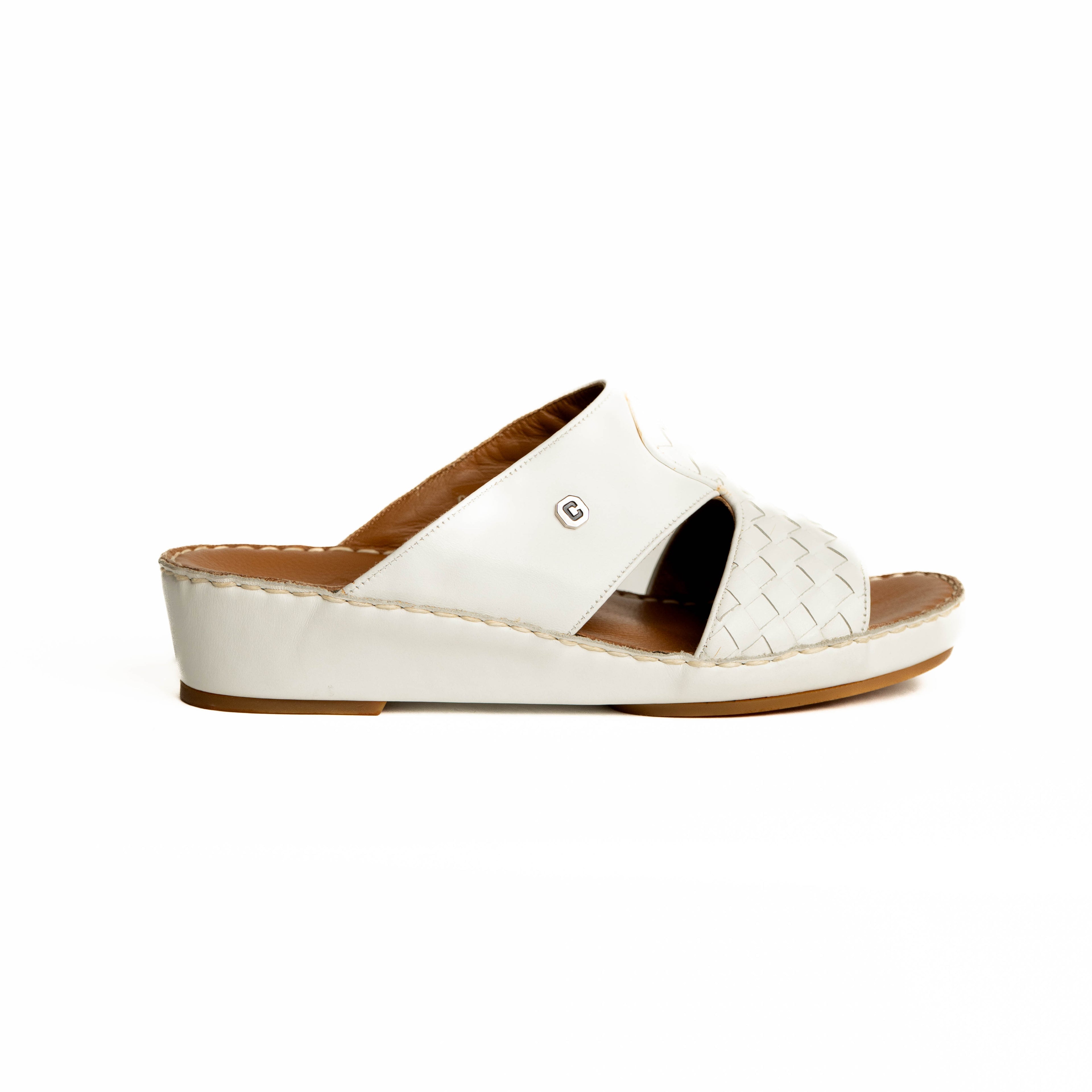 White sandal with brown sole on a white background