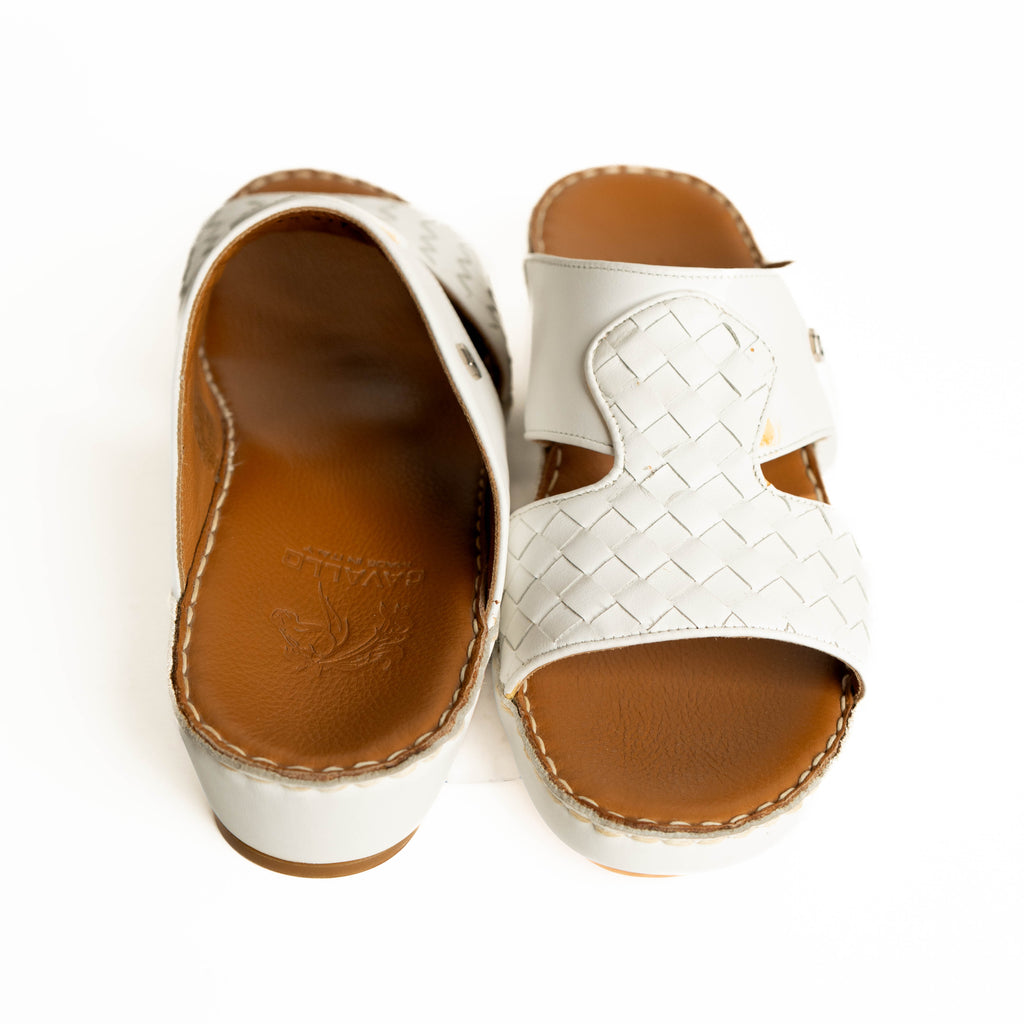 White sandals with brown soles on a white background