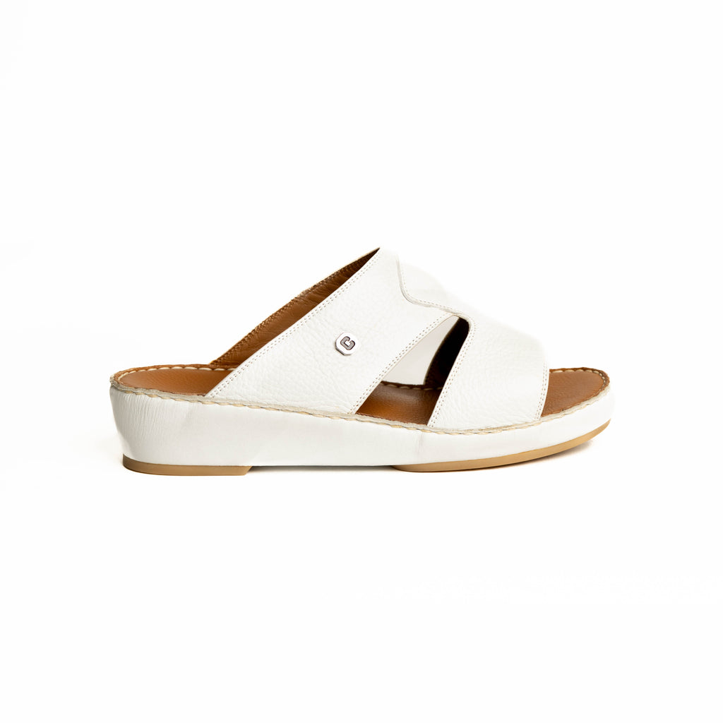 White sandal with a brown sole on a white background