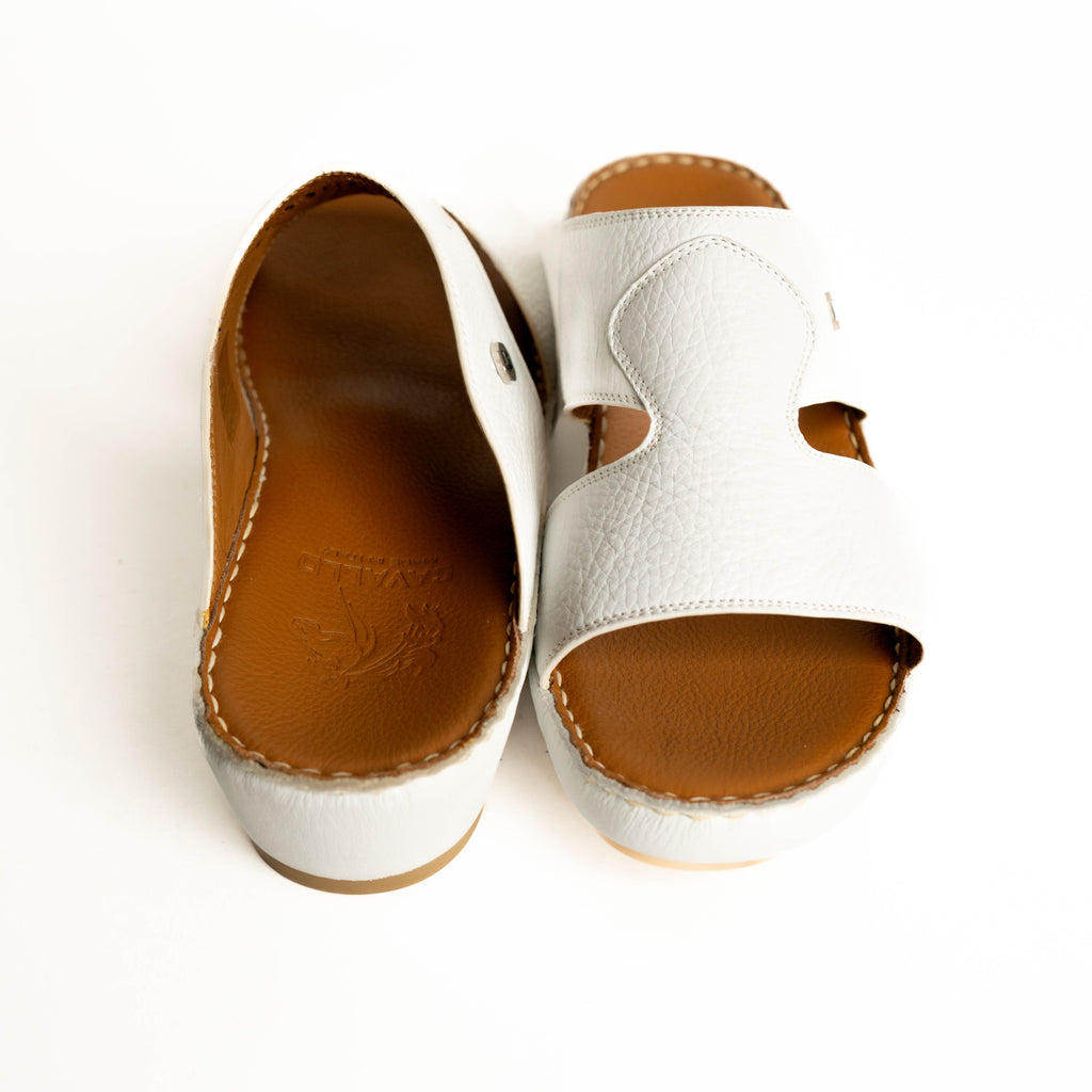 White sandals with brown soles on a white background