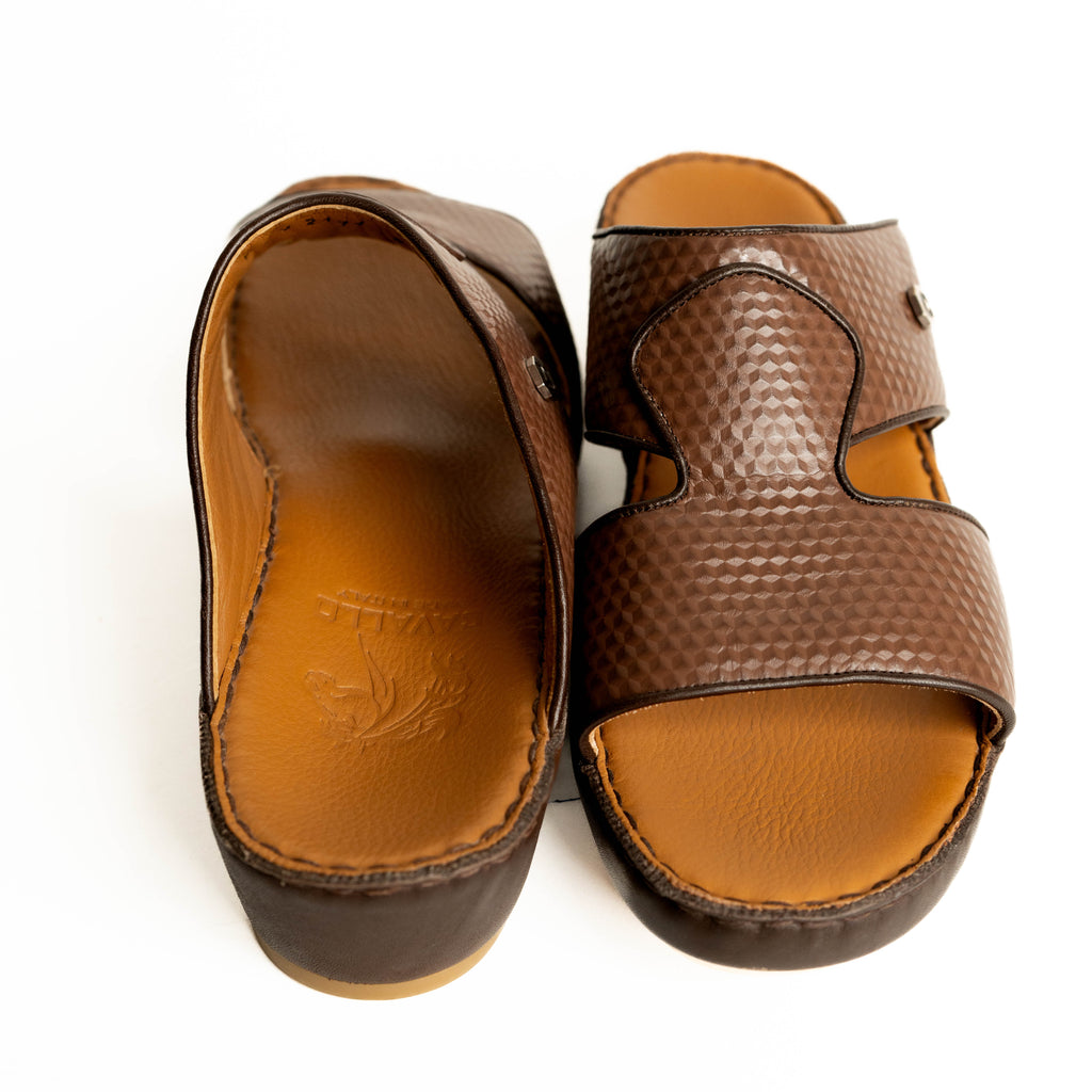 Pair of brown sandals with textured straps on a white background