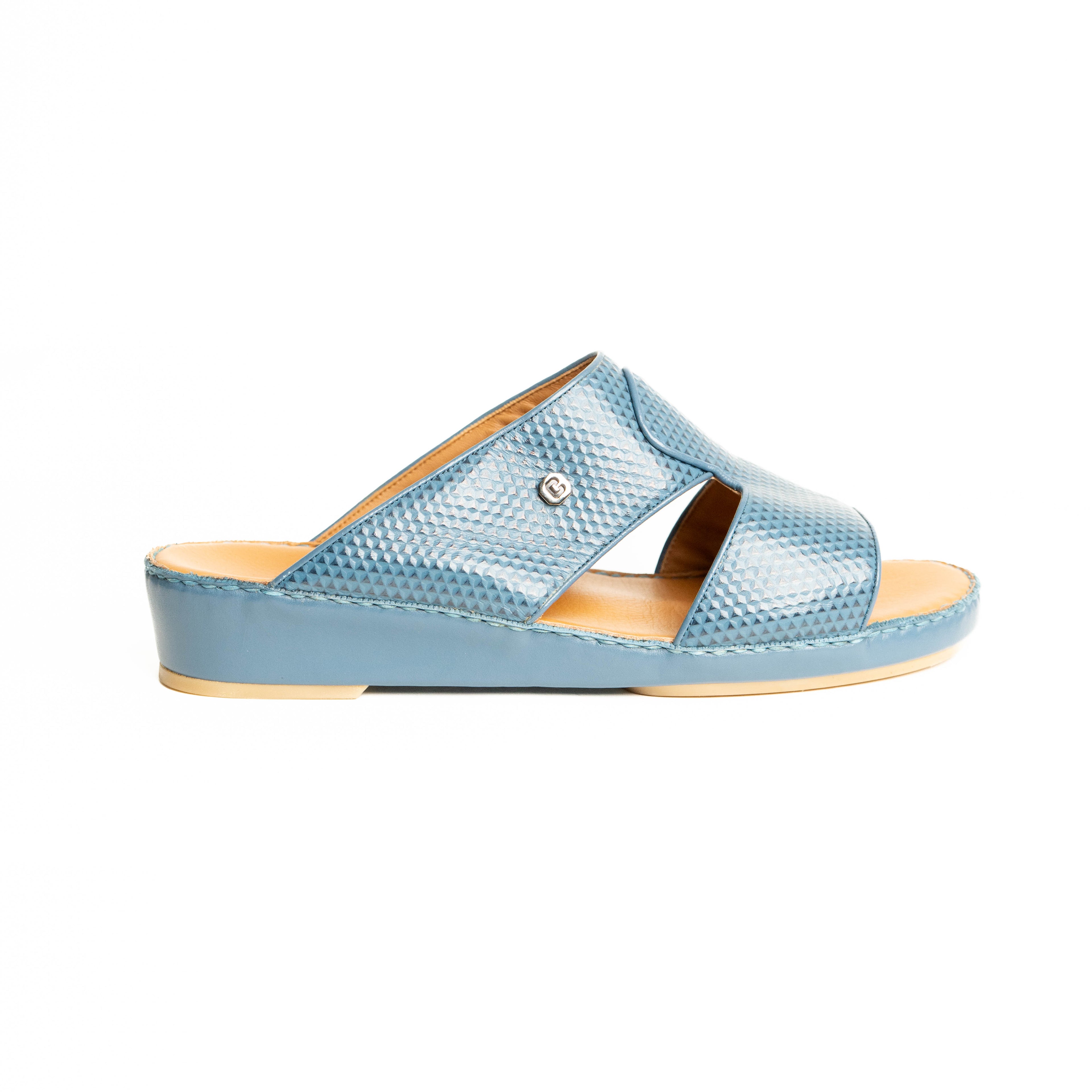 Blue sandal with a snake print on a white background