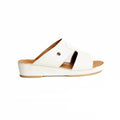 White sandal with brown sole on a white background