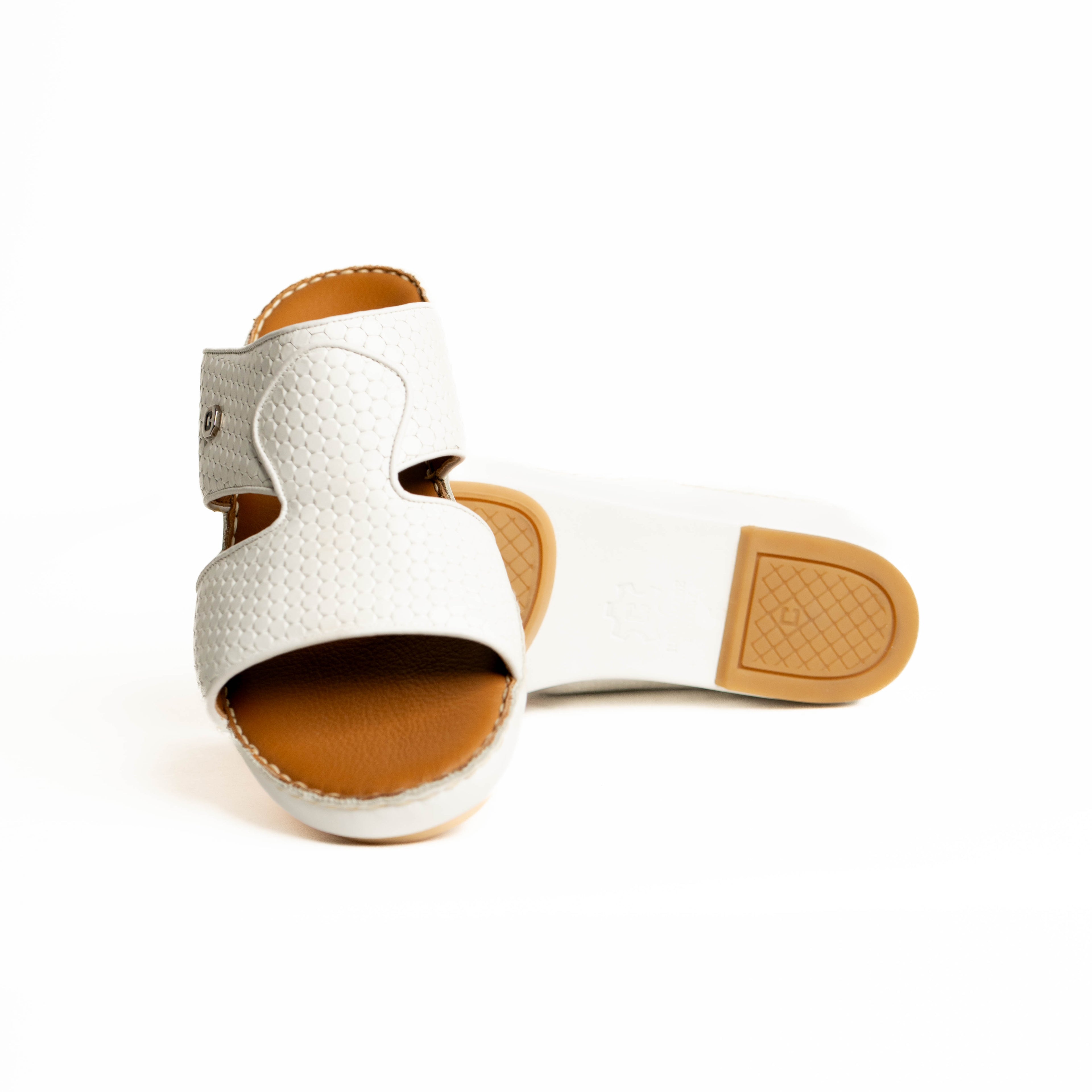 White sandal with brown sole on a white background