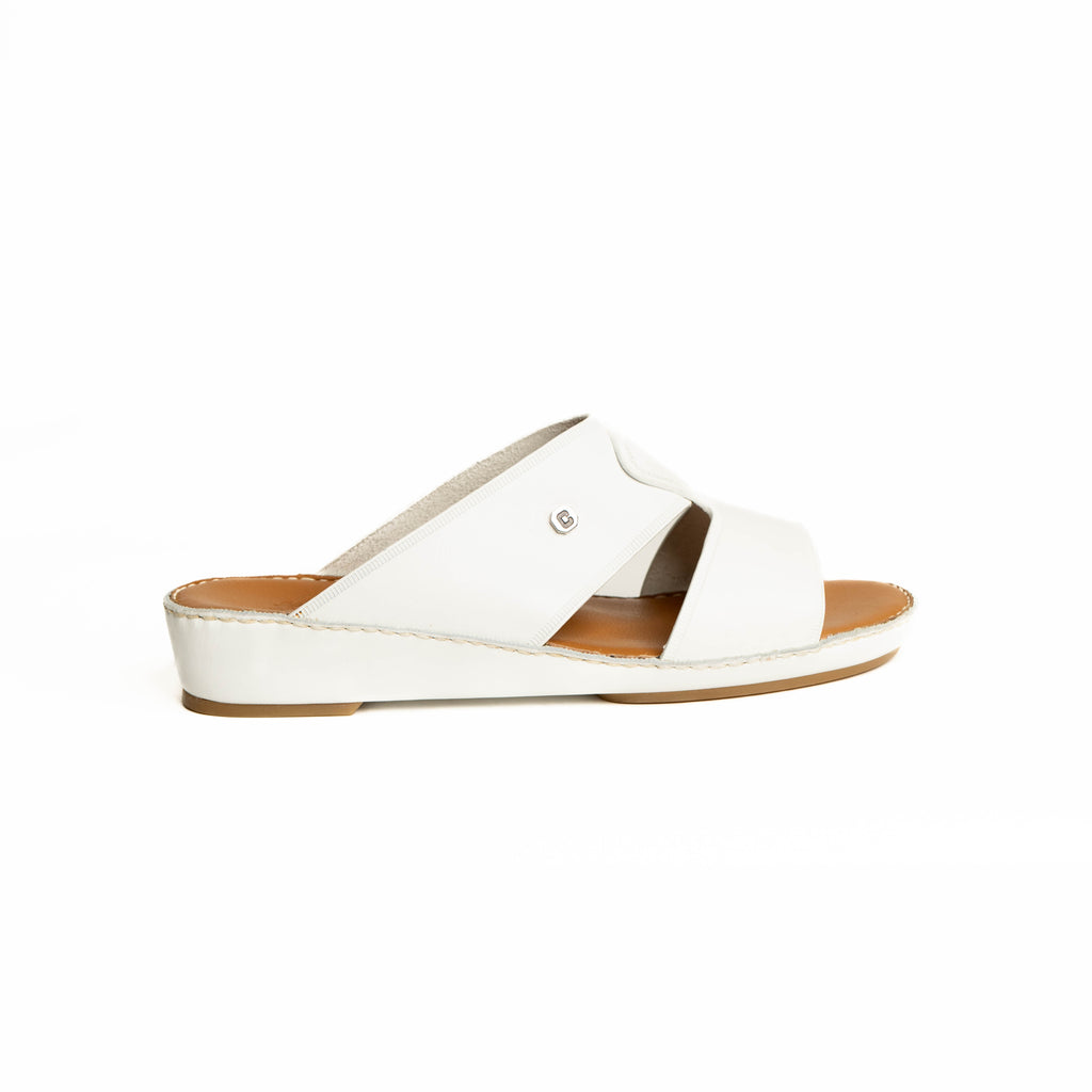 White sandal with a brown sole on a white background