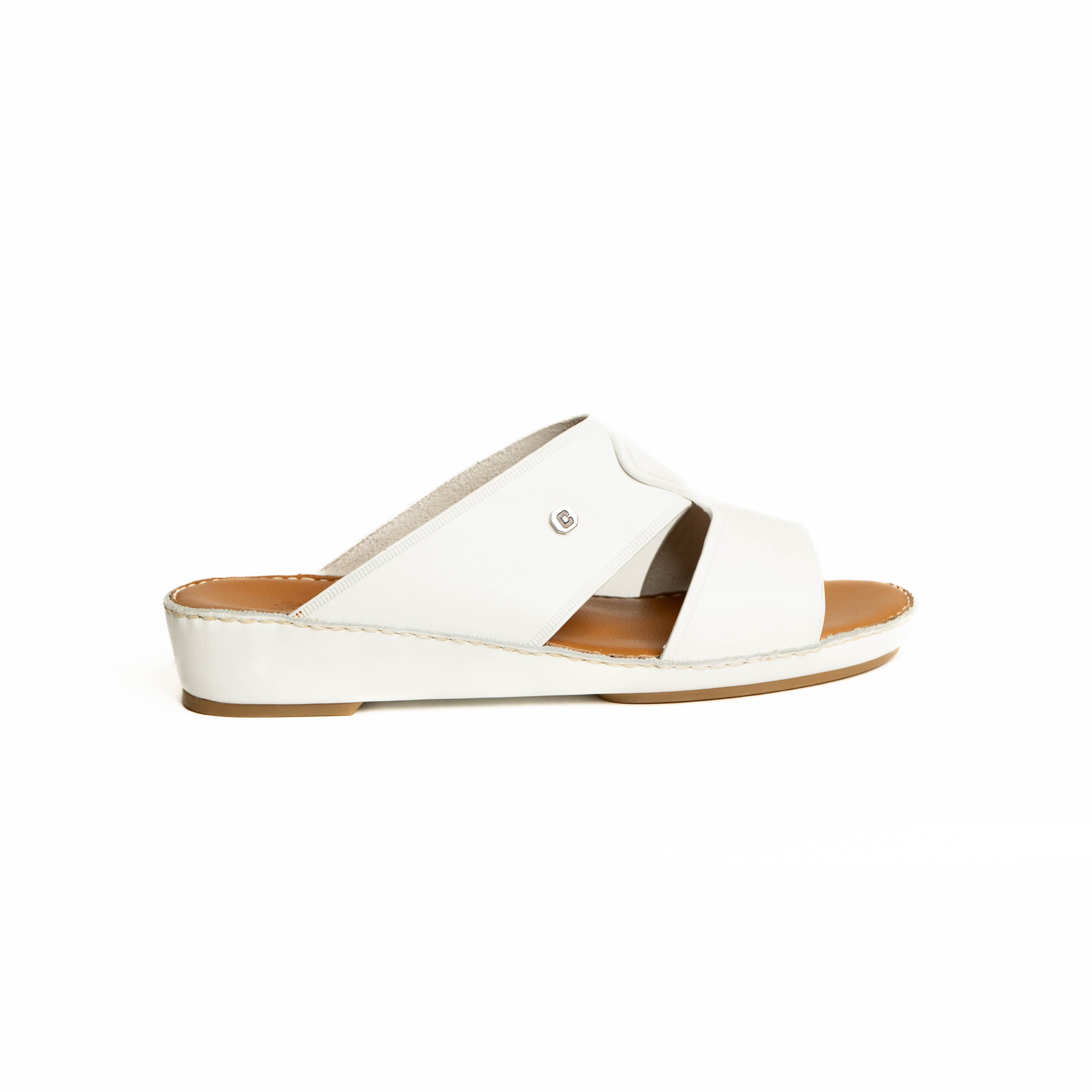 White sandal with a brown sole on a white background