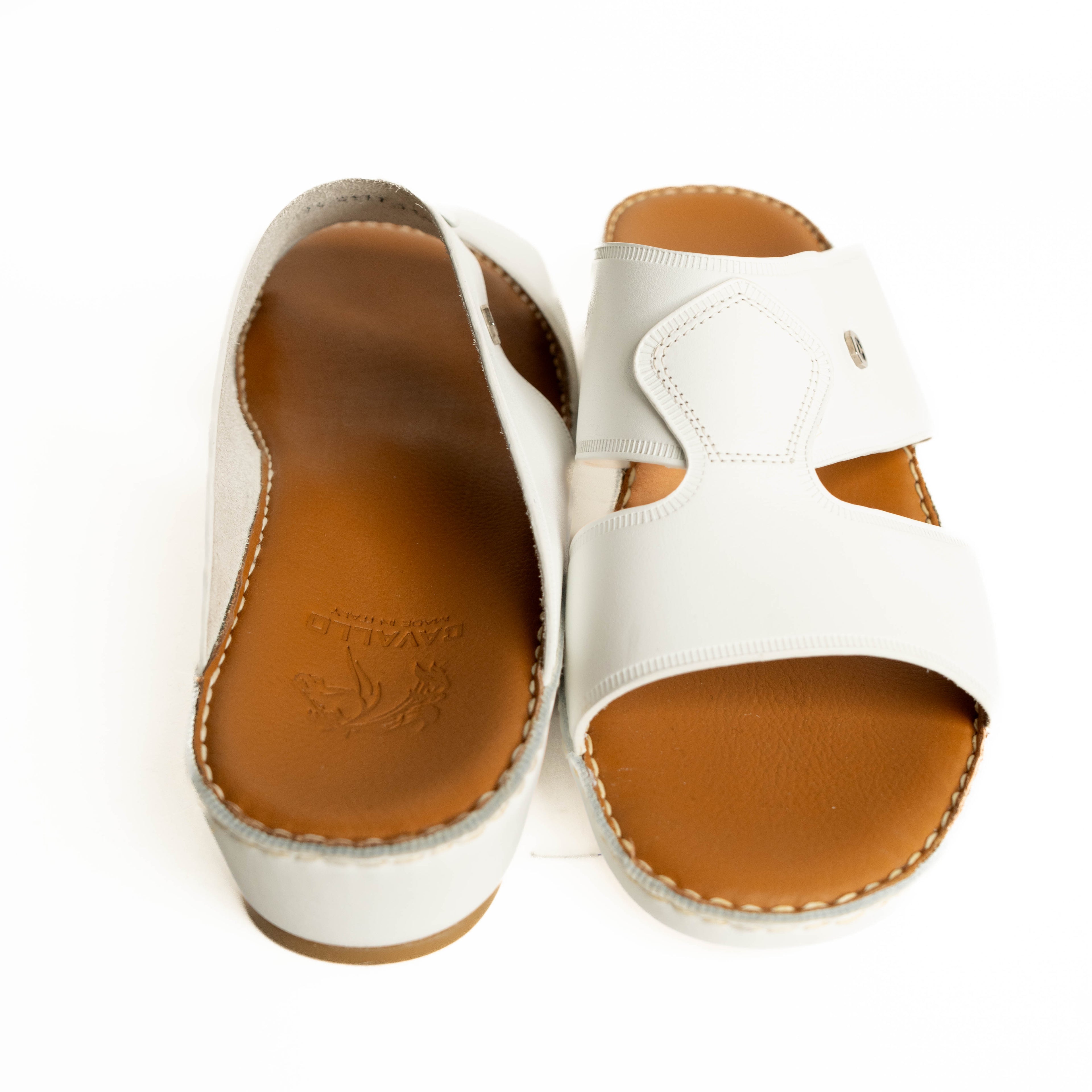 White sandals with brown soles on a white background
