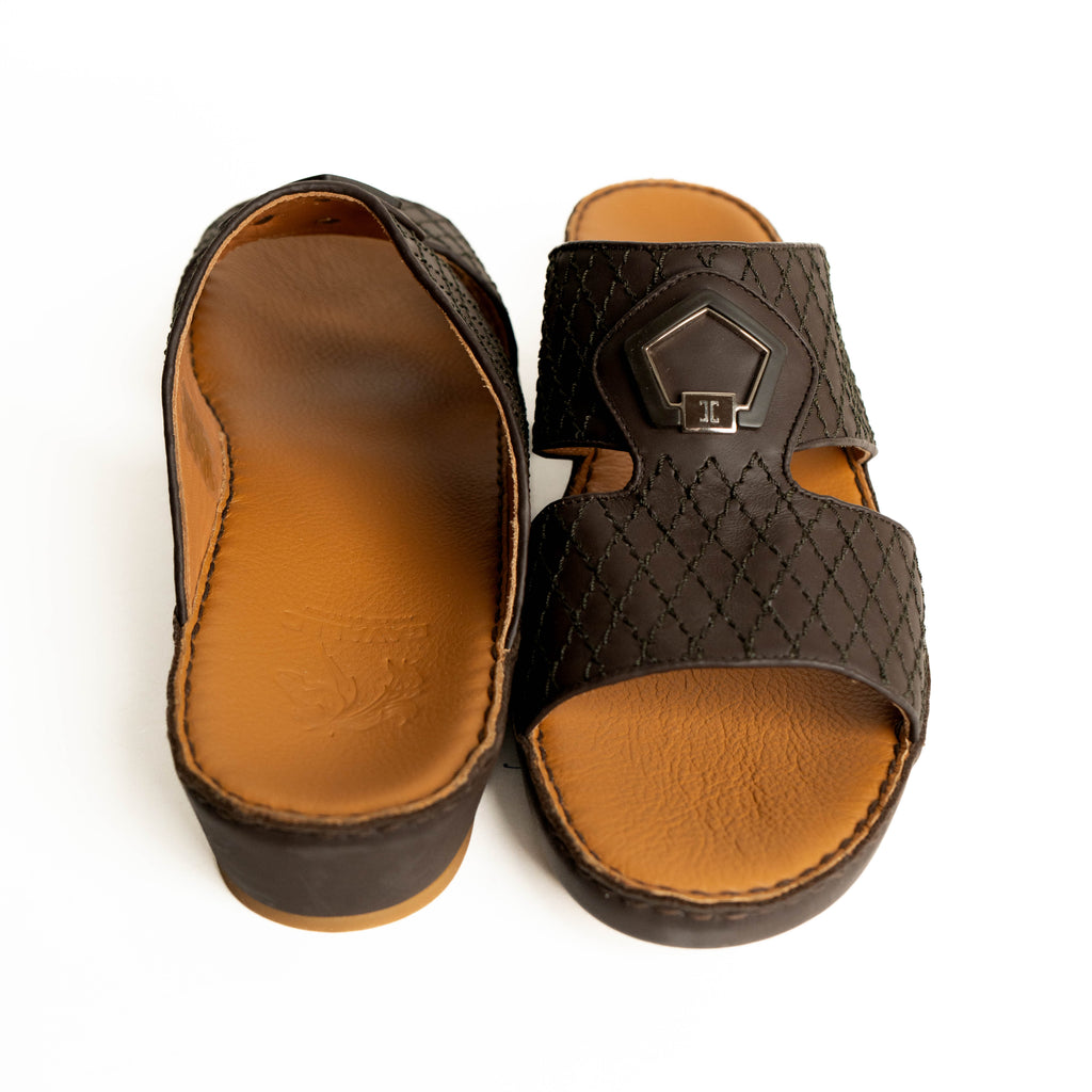Pair of brown sandals with quilted design on a white background
