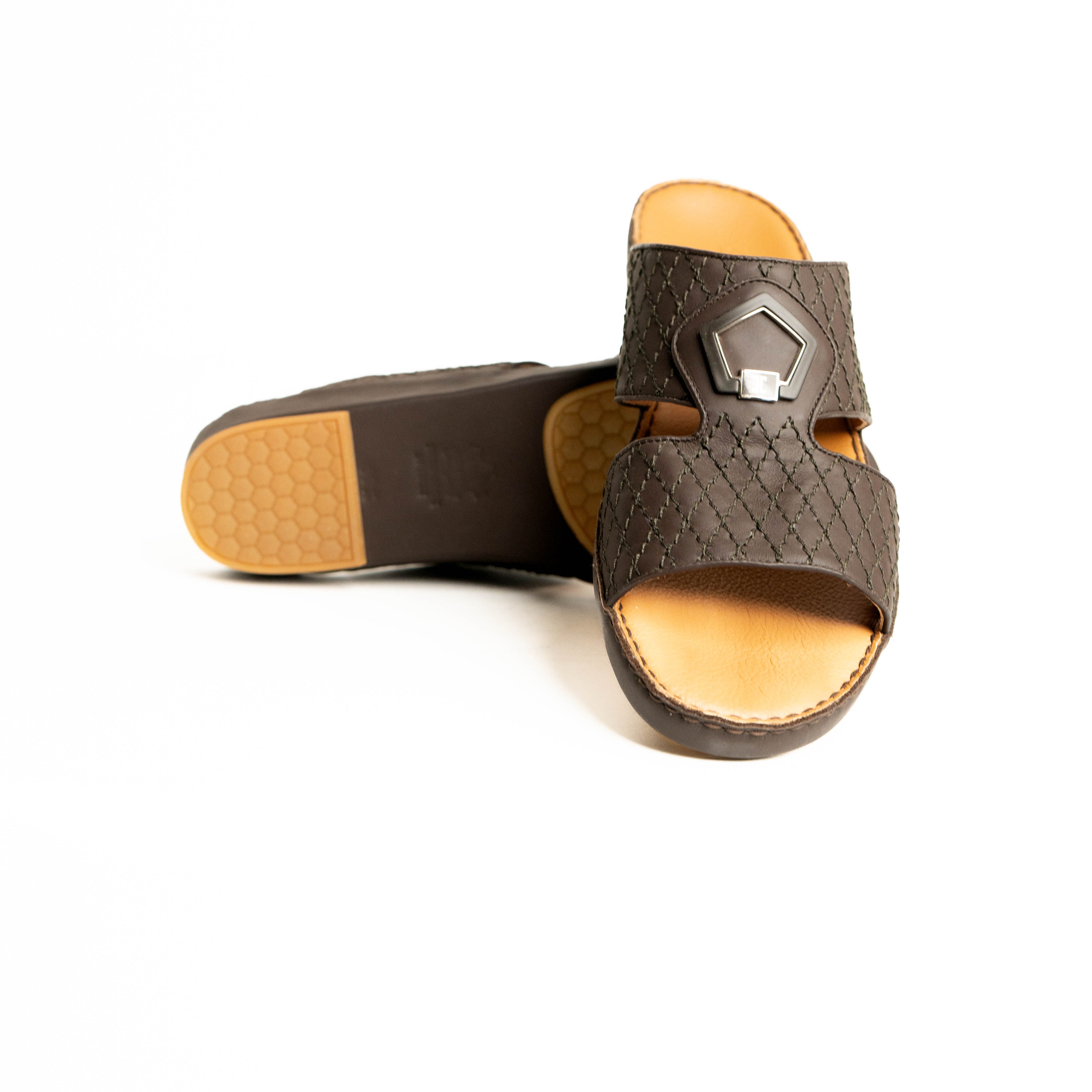 Brown sandal with a decorative buckle on a white background