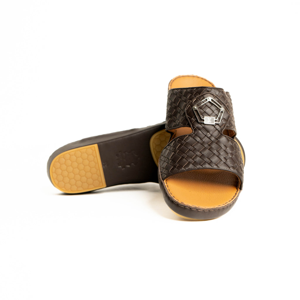 Brown woven sandal with a yellow sole on a white background