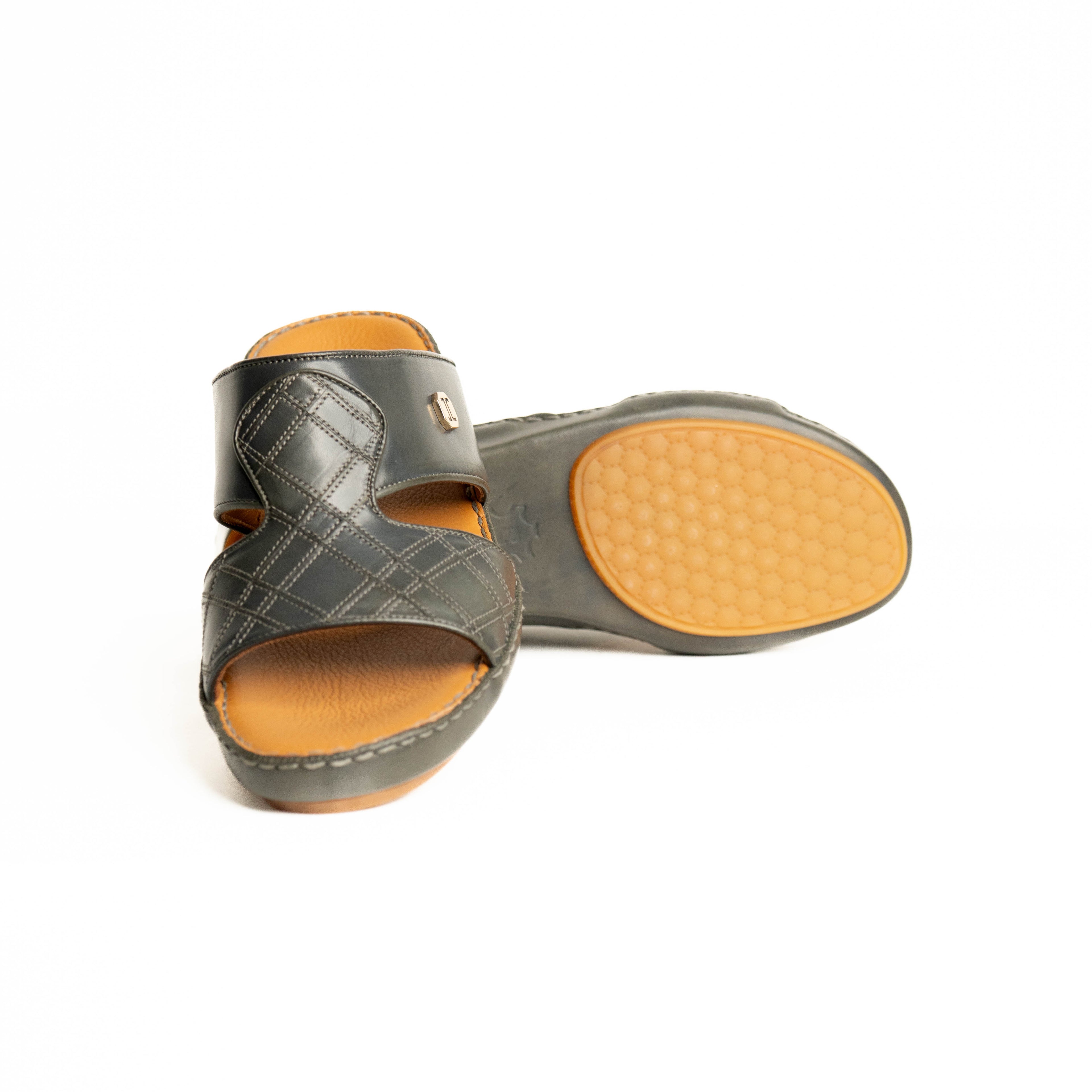 Pair of gray sandals with tan soles on a white background