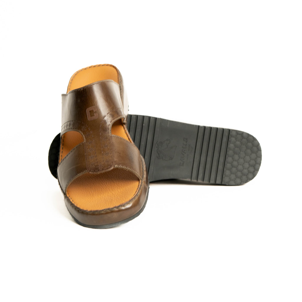 Brown sandal with black sole on a white background