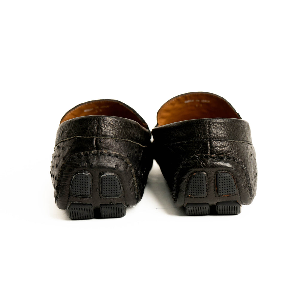 Pair of black leather loafers on a white background