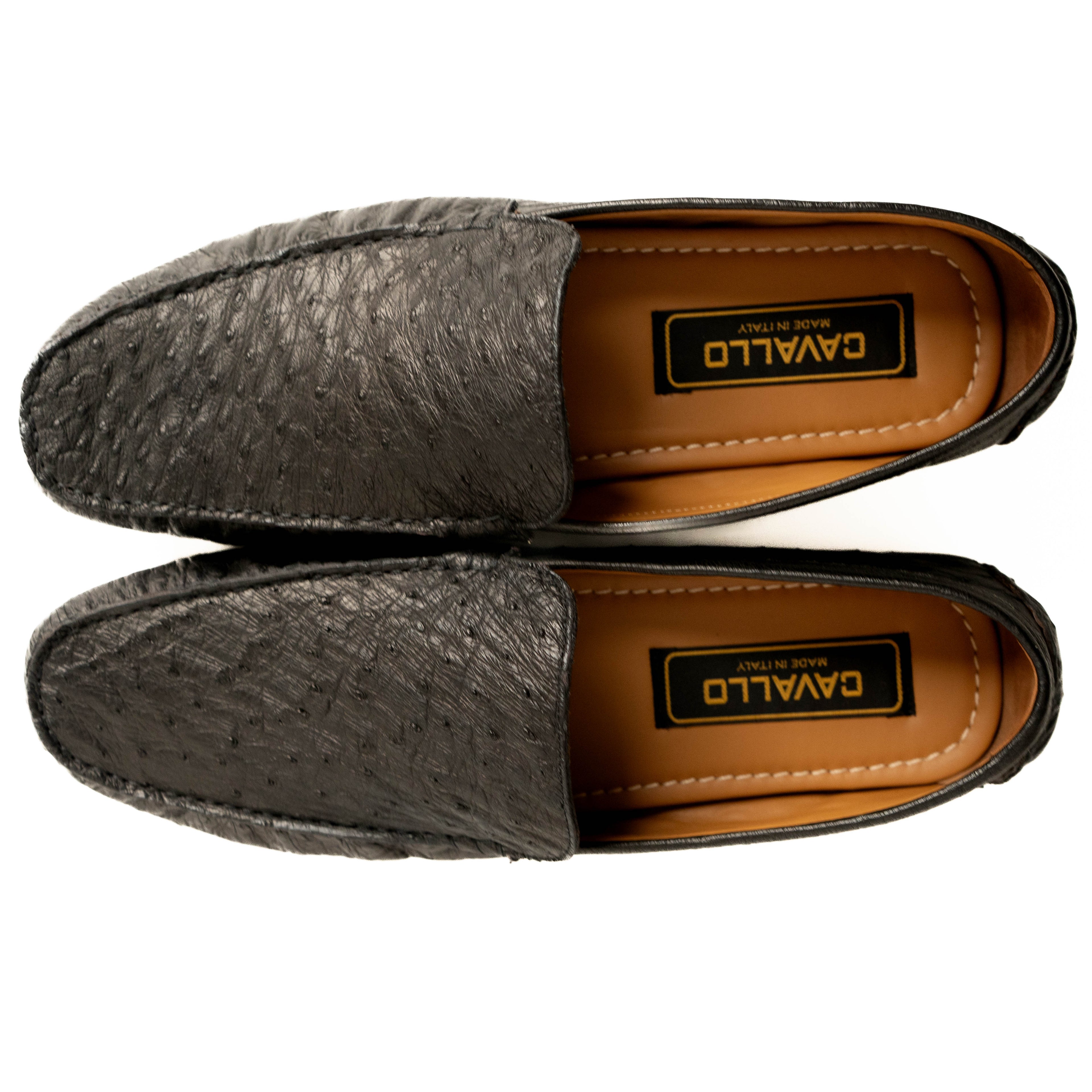 Pair of gray loafers with brown soles on a white background
