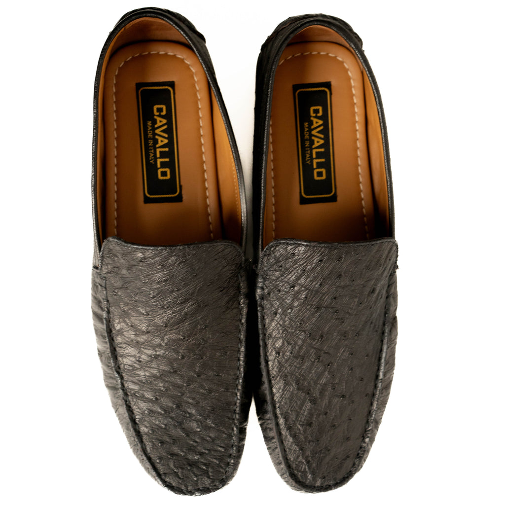 Pair of gray loafers with brown soles on a white background