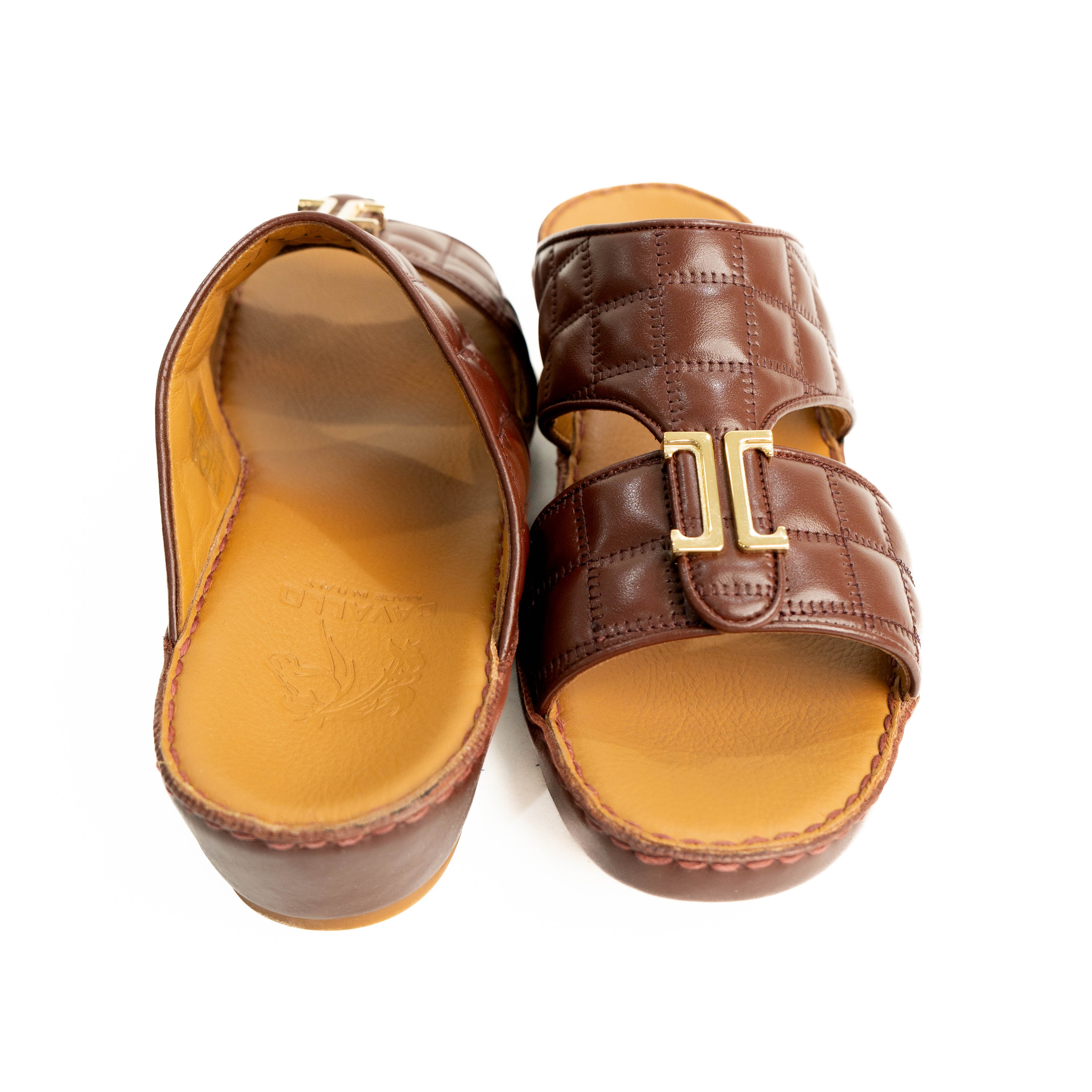Pair of brown sandals with a gold buckle on a white background