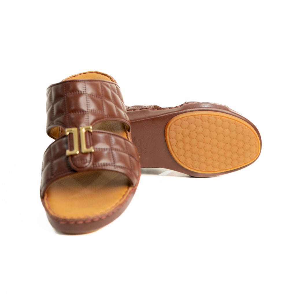 Brown sandals with a gold buckle on a white background