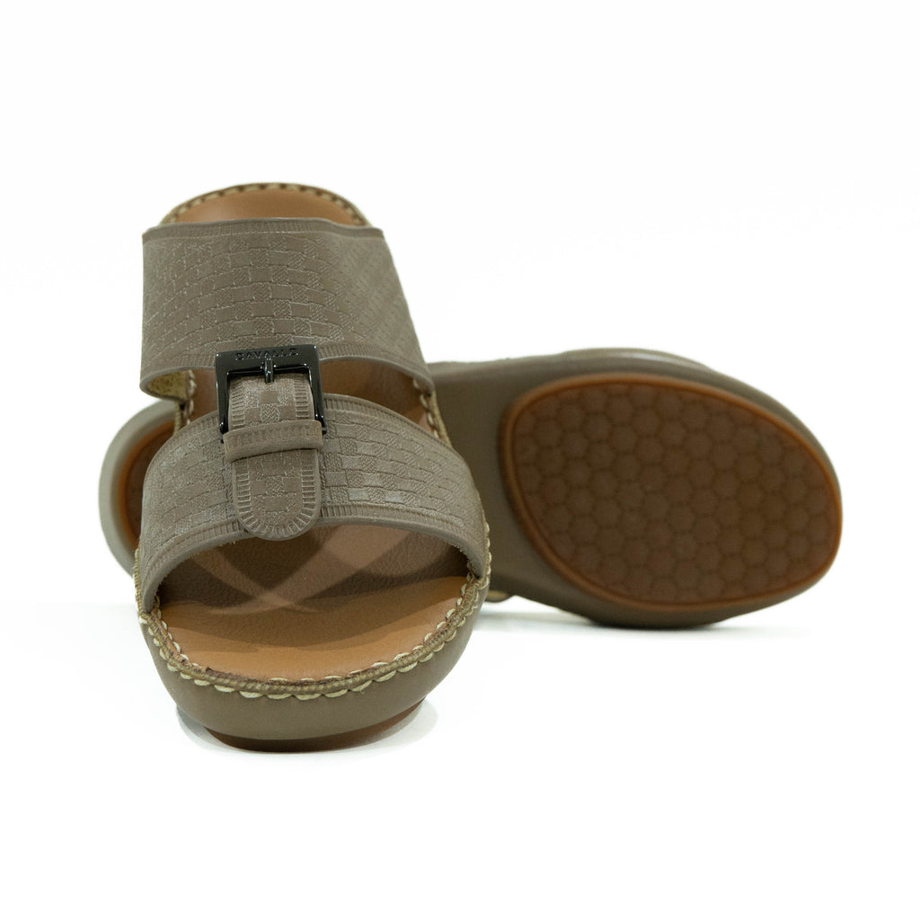 Pair of beige sandals with a buckle on a white background