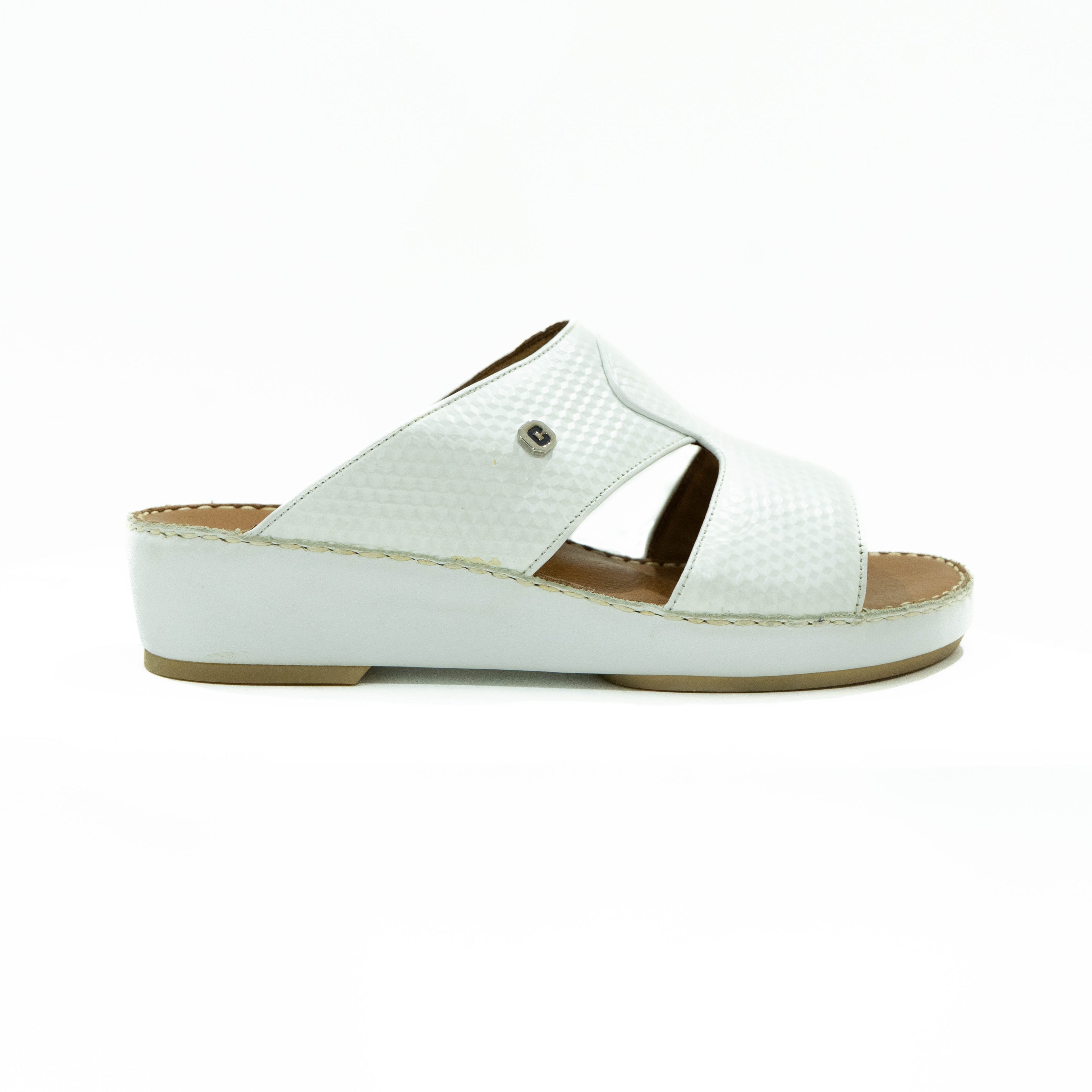 White sandal with a brown sole on a white background