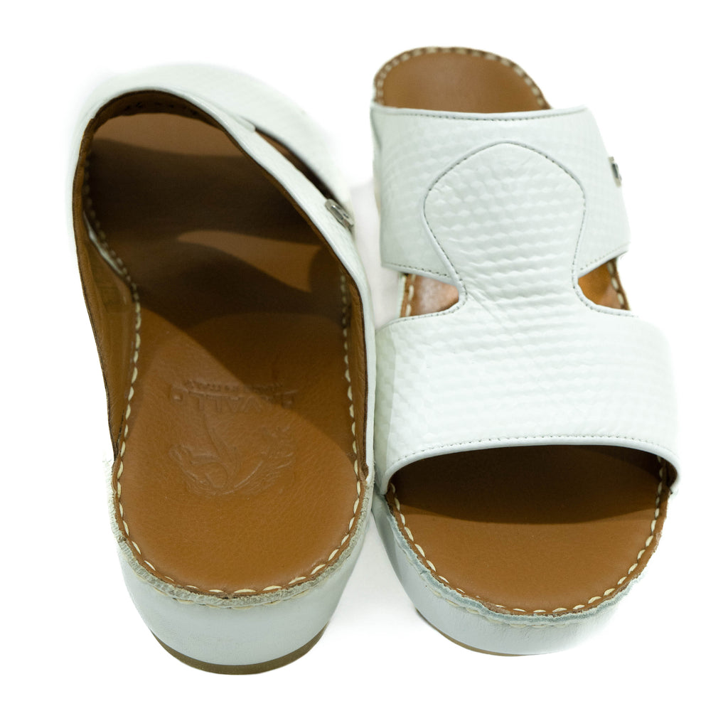 White sandals with brown soles on a white background
