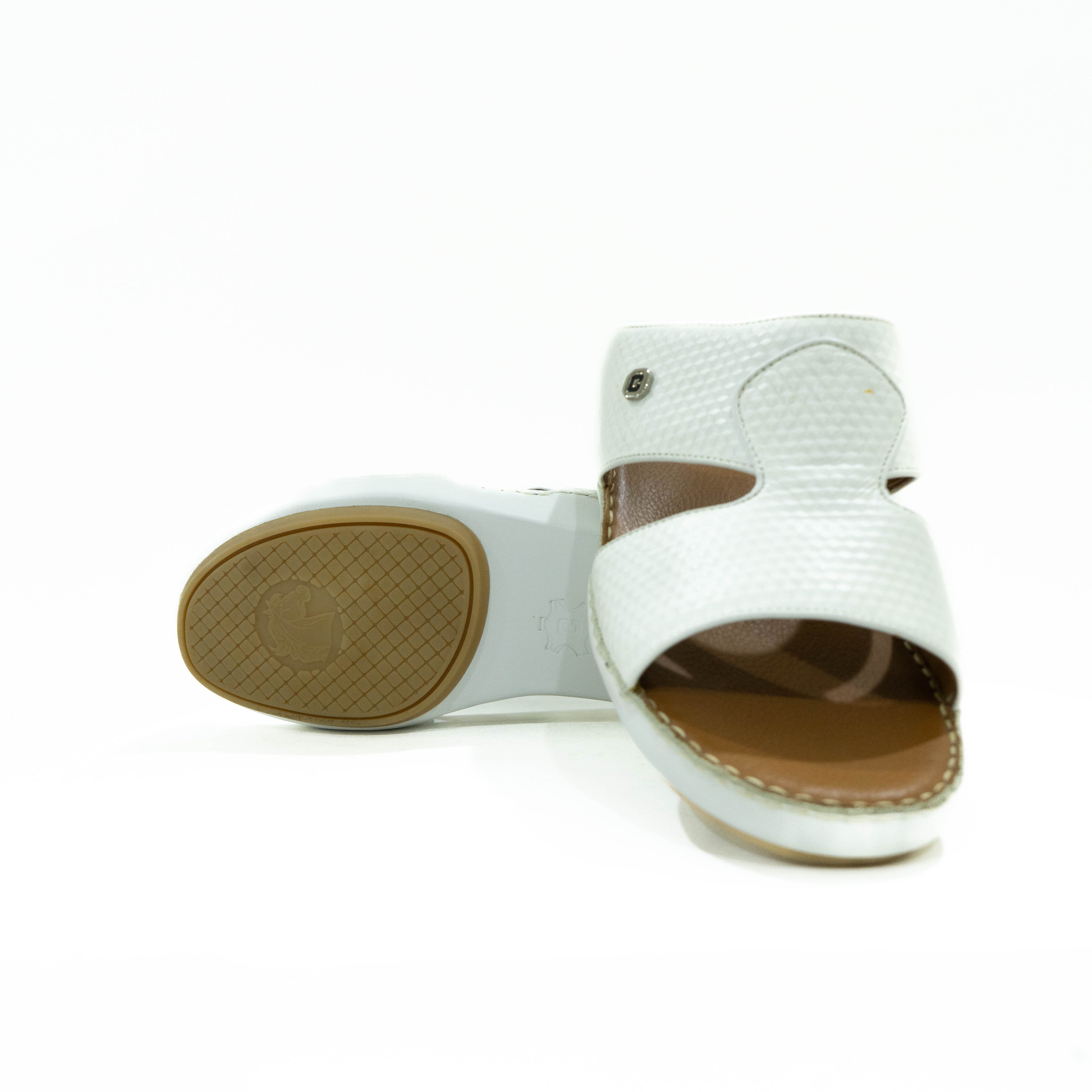 White sandal with brown sole on a white background