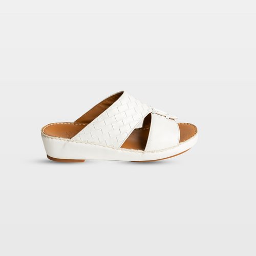 White sandal with brown sole on a light gray background