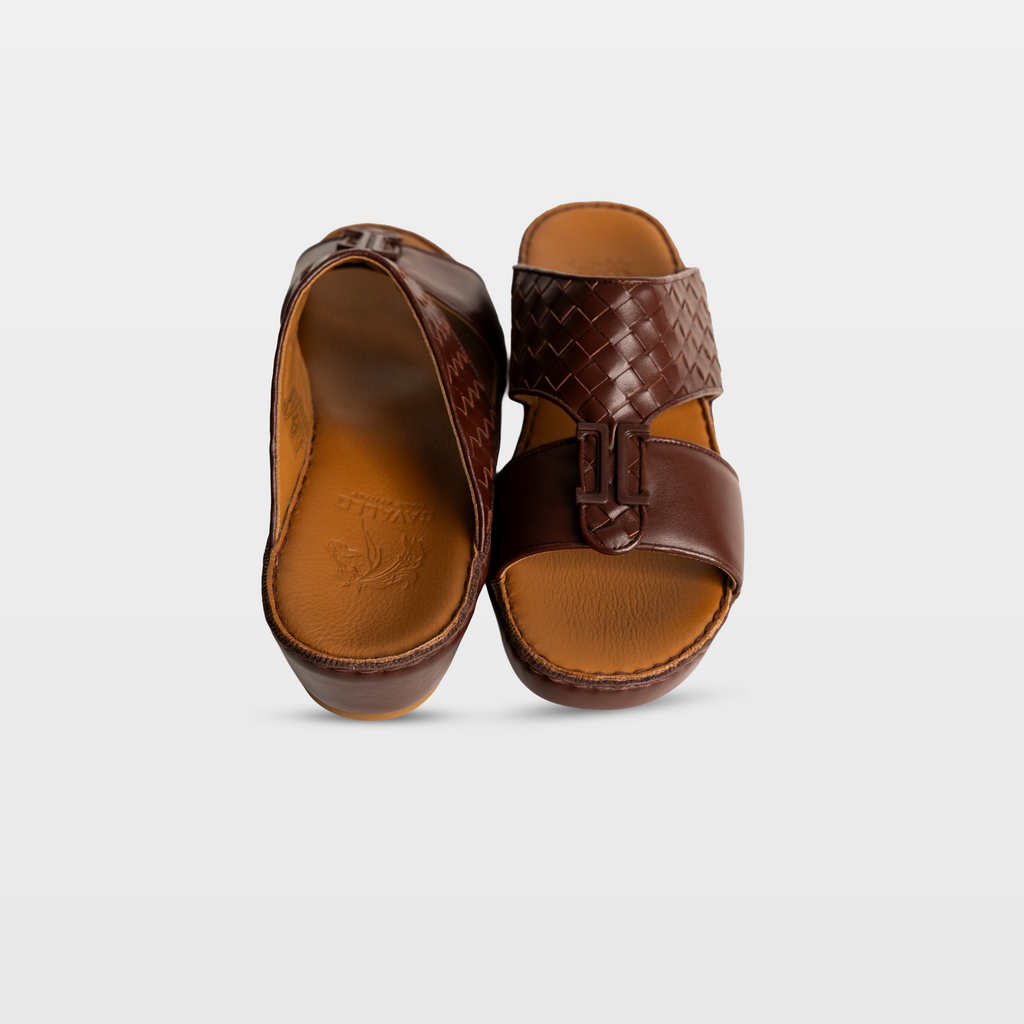 Pair of brown sandals on a light gray background